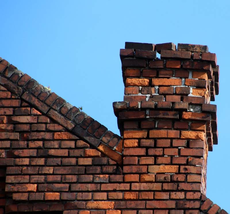 Signs Your Colleyville Home Needs a Chimney Inspection Damaged chimney on an Colleyville home showing cracks and missing mortar